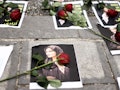 Flowers are seen on a portrait of Mahsa Amini during a demonstration in her support in front of the ...