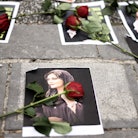 Flowers are seen on a portrait of Mahsa Amini during a demonstration in her support in front of the ...
