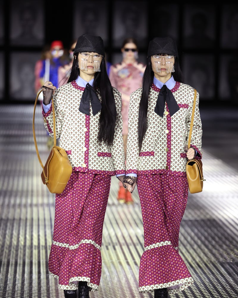 MILAN, ITALY - SEPTEMBER 23: Models walk the runway of the Gucci Twinsburg Show during Milan Fashion...