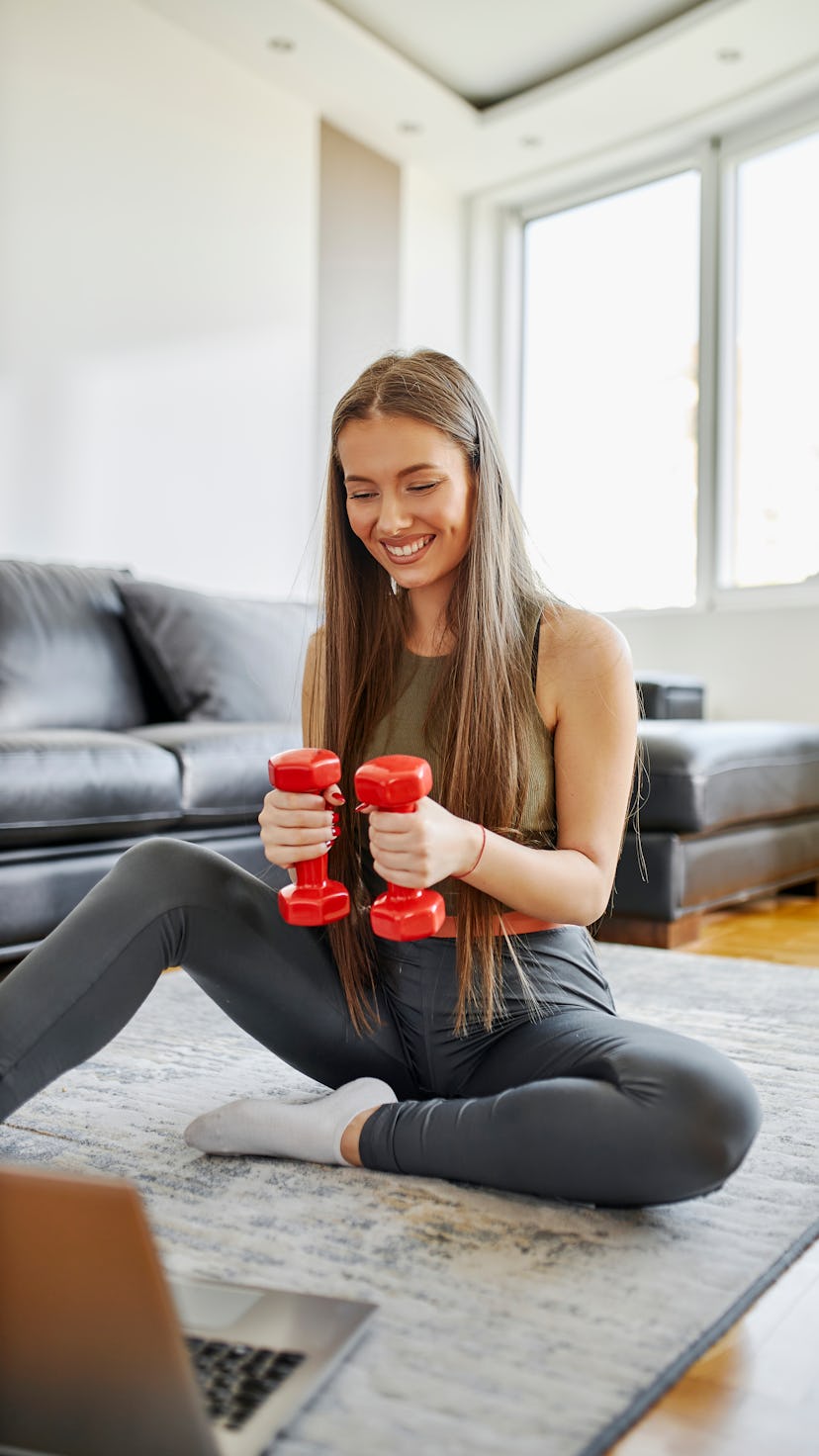 A woman doing barre exercises for arms you can do at home with weights.