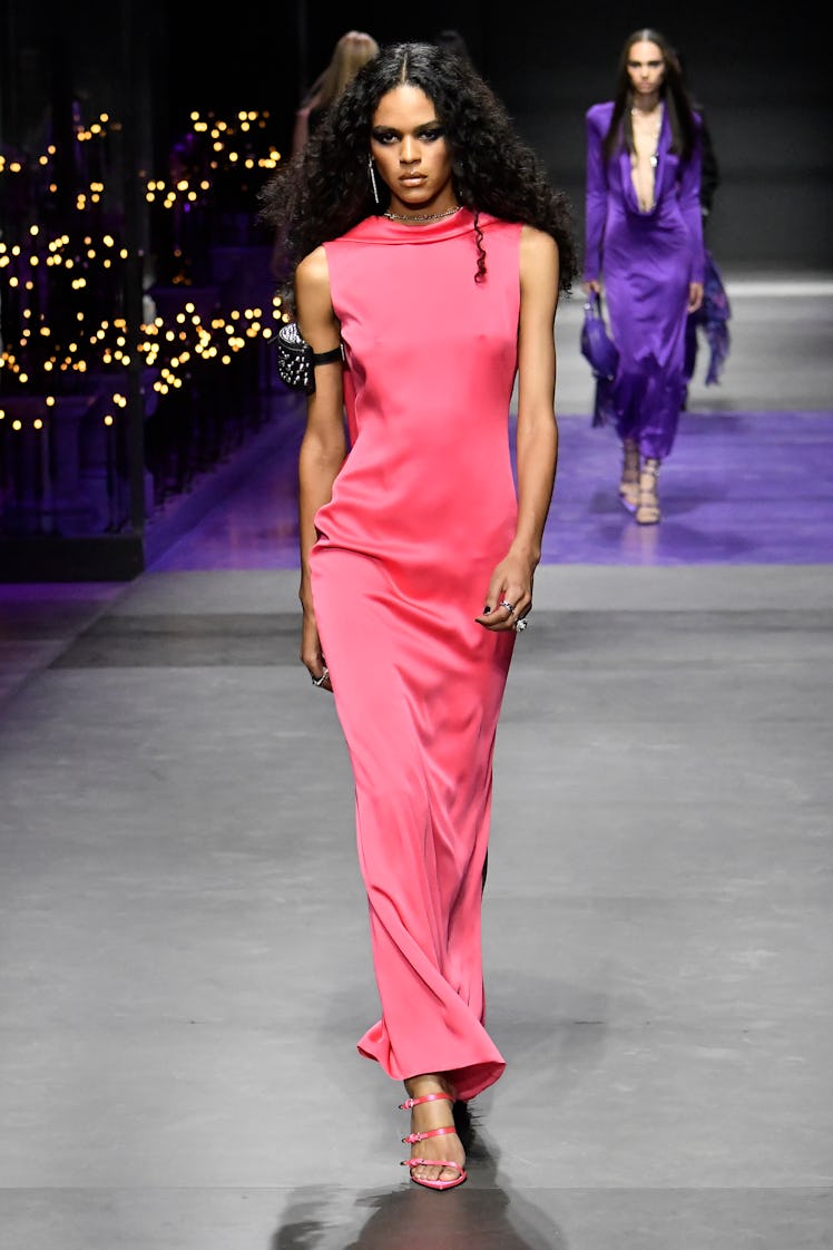 A model walking in a pink long dress during the Versace Ready to Wear Spring/Summer 2023 fashion sho...