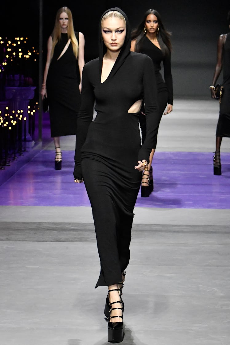 Gigi Hadid wearing a black cut-out dress from Versace's Ready to Wear Spring/Summer 2023 collection