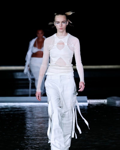 The model wears an all-white outfit with cargo pants from Andreadamo Spring/Summer 2023 Collection.
