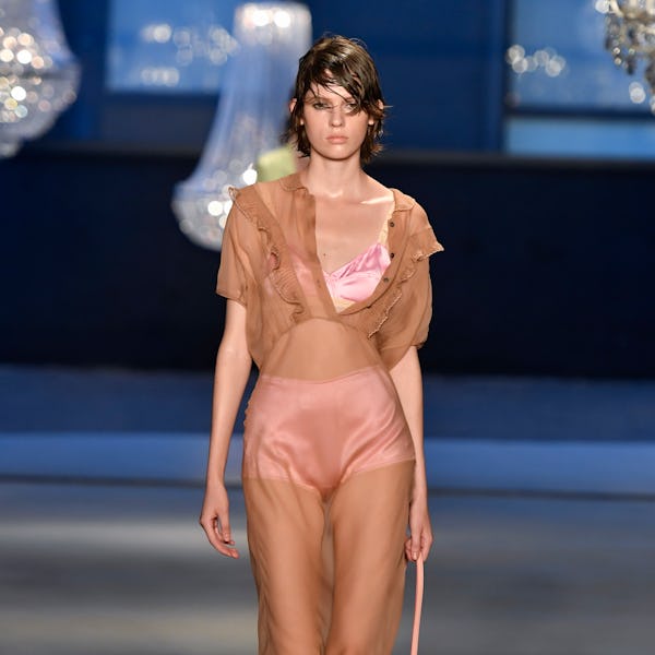 The model wears a pink satin bra and bloomers under a sheer slip by No21.