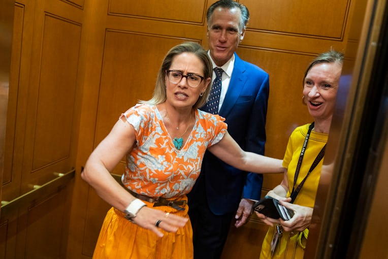 UNITED STATES - AUGUST 4: Sens. Kyrsten Sinema, D-Ariz., Mitt Romney, R-Utah, and Lisa Desjardin of ...