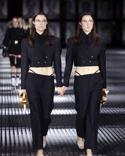 Models wear black pants with integrated visible thong straps from Gucci Spring/Summer 2023 Collectio...