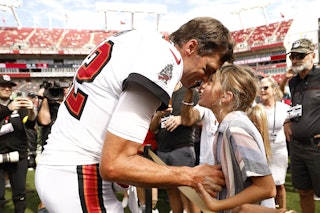 Tom Brady of the Tampa Bay Buccaneers talks with his kids before the team's home opener on Sunday. H...