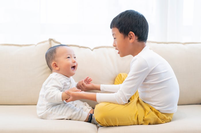 Brothers playing on sofa