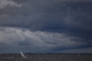 ST. PETERSBURG, FLORIDA - SEPTEMBER 27: A windsurfer cruises through the water as clouds from the ap...