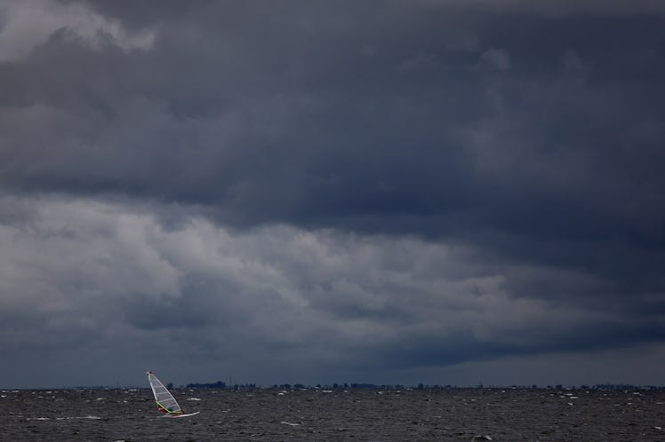 ST. PETERSBURG, FLORIDA - SEPTEMBER 27: A windsurfer cruises through the water as clouds from the ap...