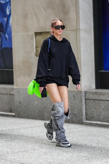 A guest at New York Fashion Week in denim leg warmers.