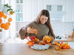 A woman making Halloween butter board ideas from TikTok at home. 