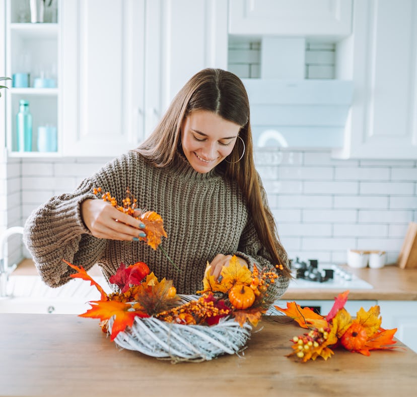 A woman making Halloween butter board ideas from TikTok at home.