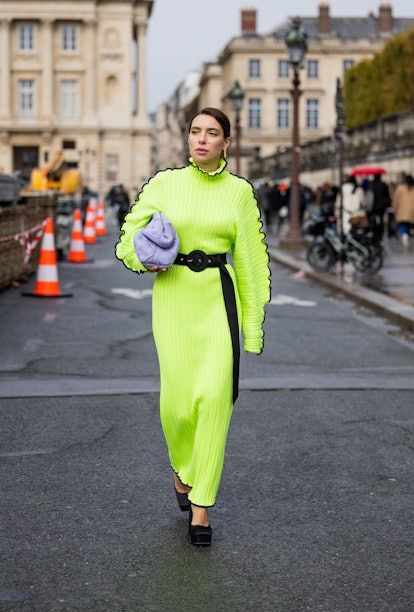 Olga Naumova wears neon dress.