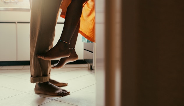 Shot of an unrecognisable couple sharing a romantic moment in the kitchen in an article about couch ...