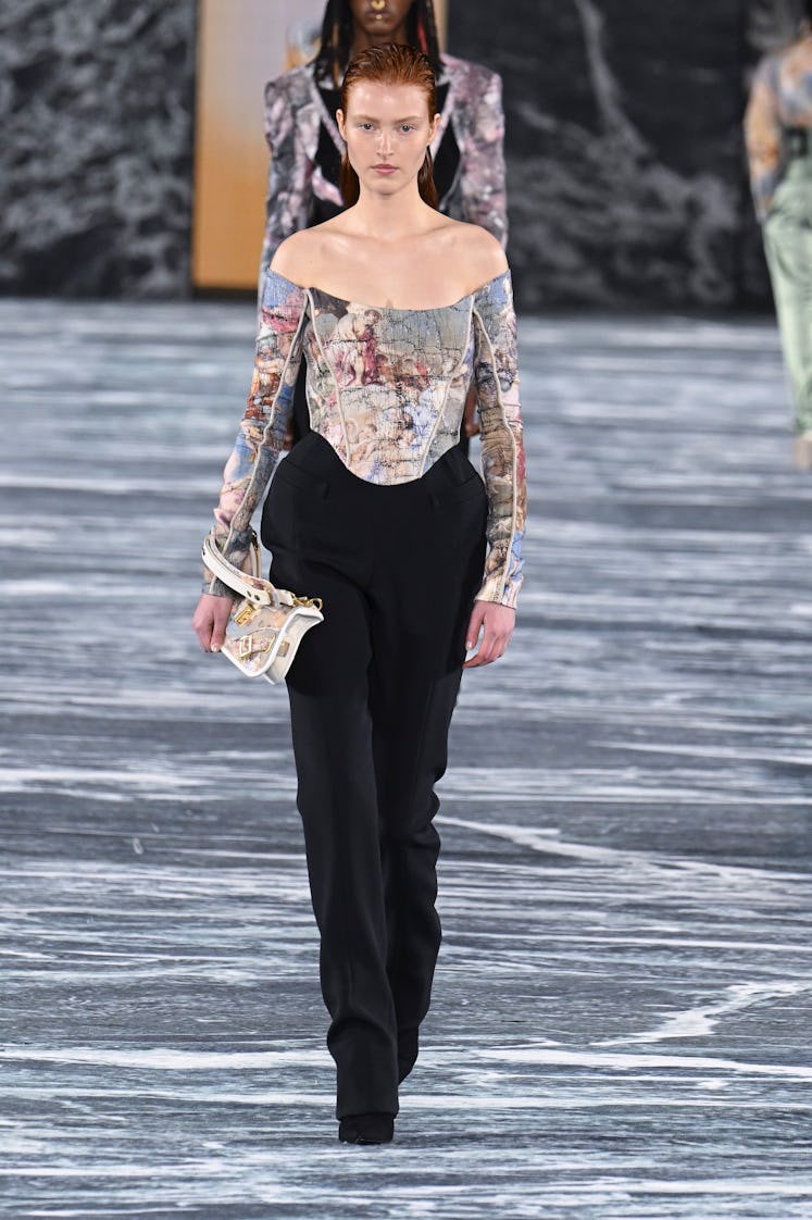 A model wearing Balmain’s multicolor corset long-sleeved top and black pants at Paris Fashion Week 2...
