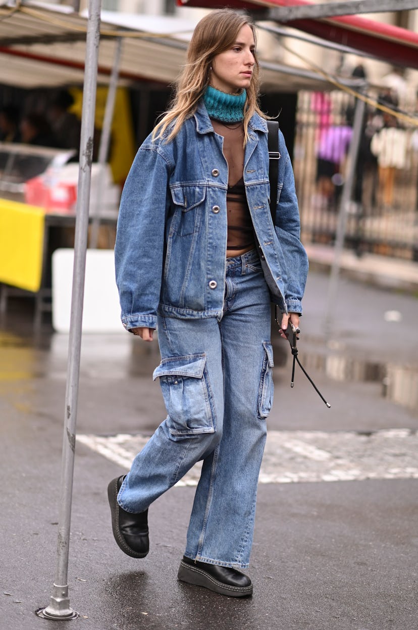 A guest is seen wearing a jean jacket, jean pants and black sheer top 