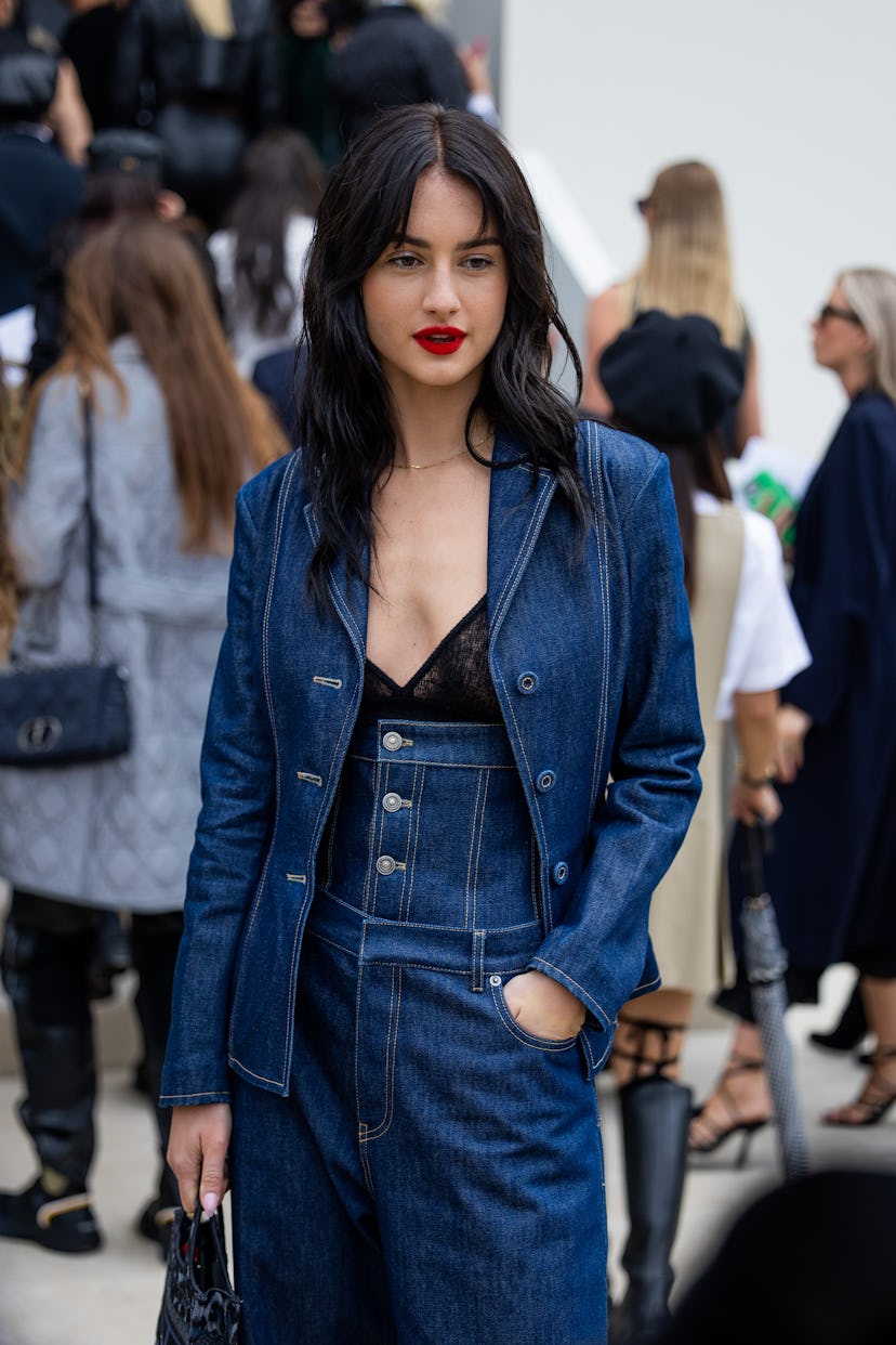 Grace Van Patten wears denim blazer, corset, denim jeans.