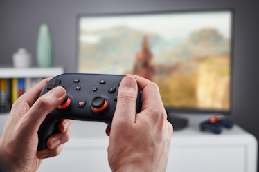 Detail of hands holding a Google Stadia video game controller, taken on November 27, 2019. (Photo by...