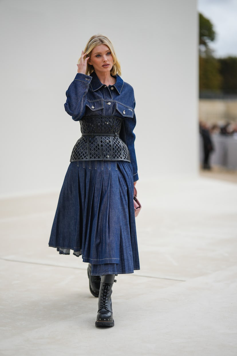 Elsa Hosk wears a navy blue denim shirt / pleated long dress from Dioroutside Dior