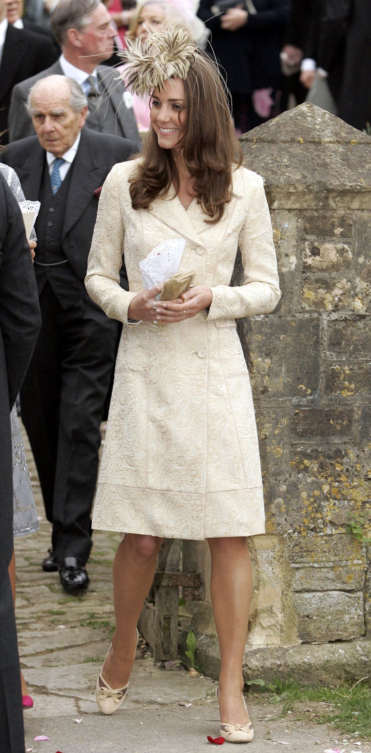 Kate Middleton wears a feather fascinator as part of Kate Middleton's fashion evolution while she at...