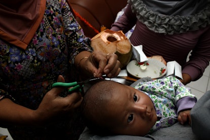 Muslim ceremony called Akikah for newborn child, which includes a first haircut.