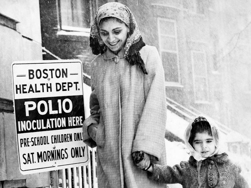 BOSTON, MA - MARCH 24: Ms. Driscoll with Daniel, 3 years old, head towards a polio vaccine inoculati...