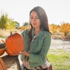 A woman shopping for pumpkins uses October quotes for Instagram captions.