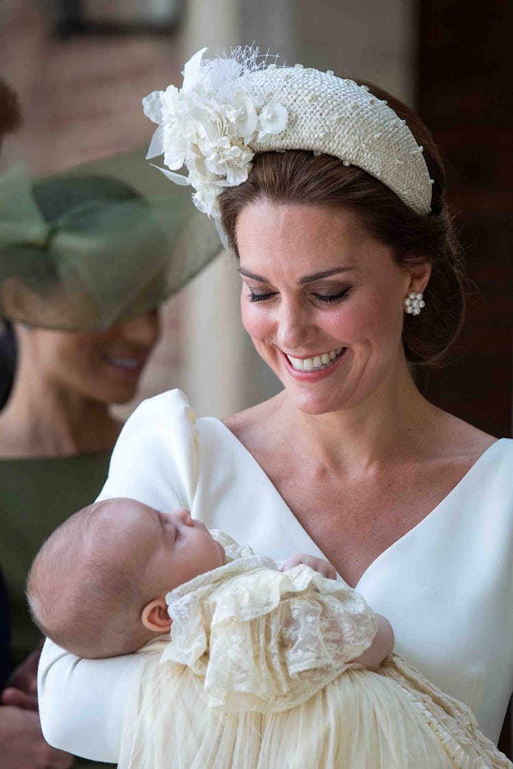 Kate Middleton wears a padded headband while she holds Britain's Prince Louis of Cambridge on their ...