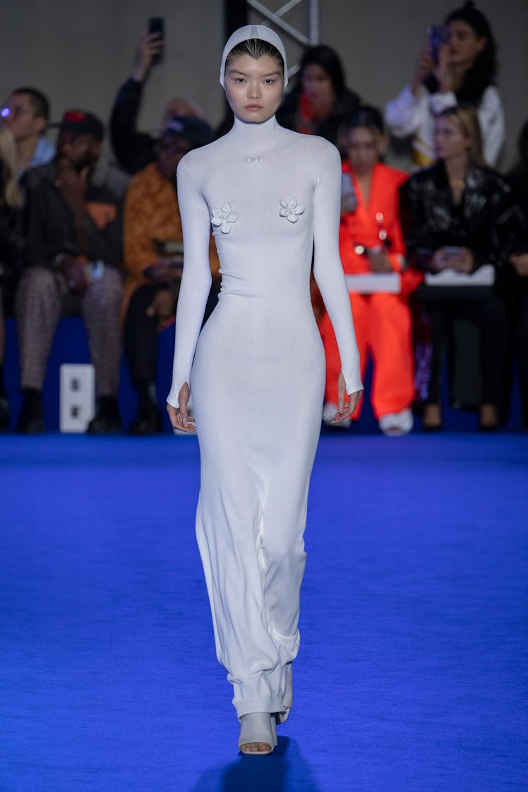 A model walking the runway at the Off White Ready to Wear Spring/Summer 2023 fashion show in a white...