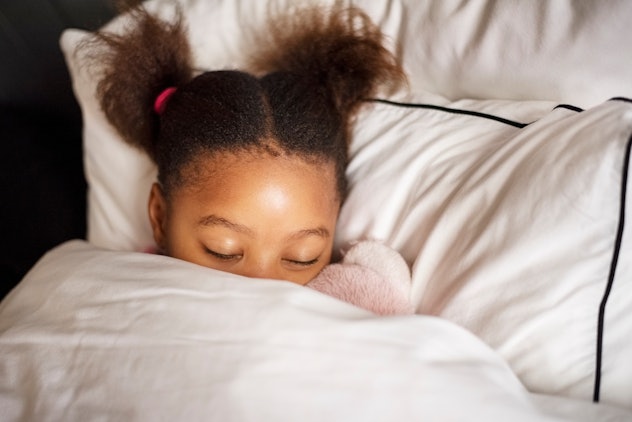 Close-up of a little girl sleeping peacefully in her bed, relieving her cough
