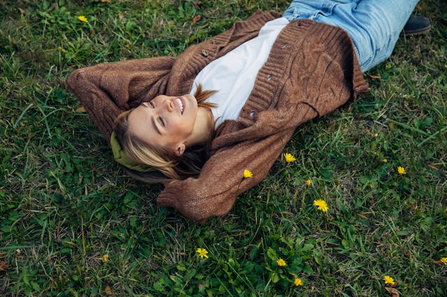 Woman in field wearing women's cardigan