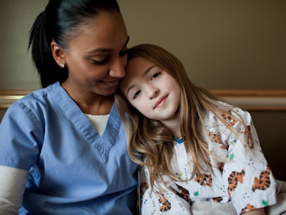 child and nurse in an article about what to say to a friend with a child in the PICU