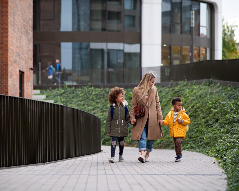 nanny picking up kids from school in an article about how to help child get used to a new nanny