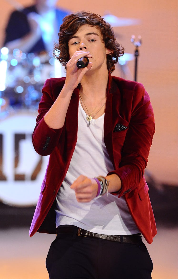 Harry Styles Style Evolution: Styles wore a velvet blazer as One Direction performs during the BBC C...