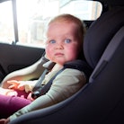Cars.com released its Car Seat Fit checklist. Here, a baby girl sits her car seat in the back of the...