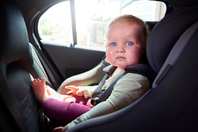 Cars.com released its Car Seat Fit checklist. Here, a baby girl sits her car seat in the back of the...