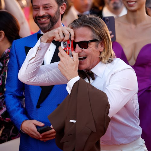 VENICE, ITALY - SEPTEMBER 05: Chris Pine takes a picture on the "Don't Worry Darling" red carpet at ...