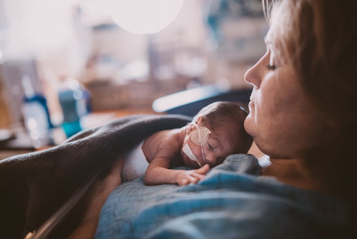 A mom holds her baby on her chest while in the NICU.