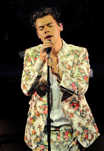 Harry Styles's Style Evolution: Harry Styles in a Gucci suit performs on the Tour Opening Date at Th...
