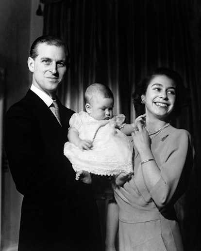 Princess Elizabeth and the Duke of Edinburgh hold their first child Prince Charles, aged 6 months.  ...