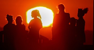 LONG BEACH, CALIF. - SEPT. 1, 2022. The blazing sun silhouettes visitors to Signal Hill after anothe...