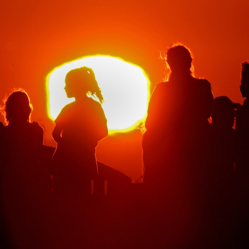 LONG BEACH, CALIF. - SEPT. 1, 2022. The blazing sun silhouettes visitors to Signal Hill after anothe...