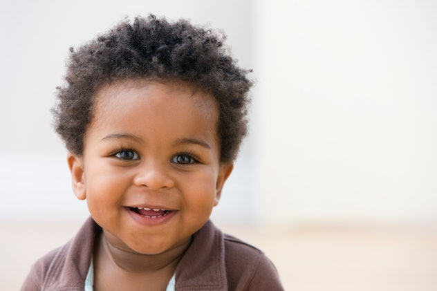 a cute little toddler boy smiling at the camera in an article about boy names that start with C