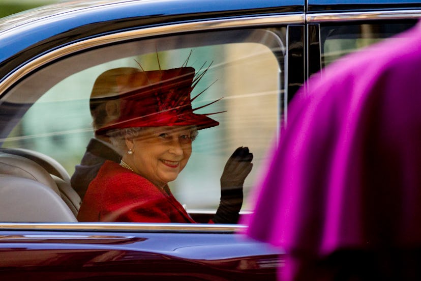 Britain's Queen Elizabeth II (L) waves to Archbishop of Canterbury Rowan Williams (R) as she departs...