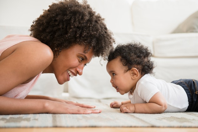 cute boy doing tummy time head-to-head with his mom in an article about boy names that start with C