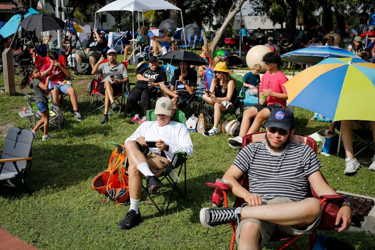 People wait for the launch of the Artemis I unmanned lunar rocket, in Titusville, Florida, on Septem...