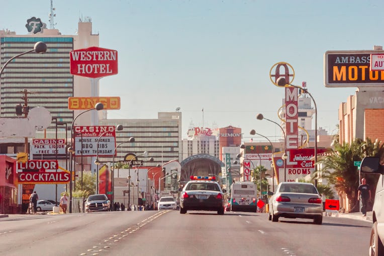 We see an old photo of downtown Las Vegas, this is the old town part of Las vegas, we see traffic, h...
