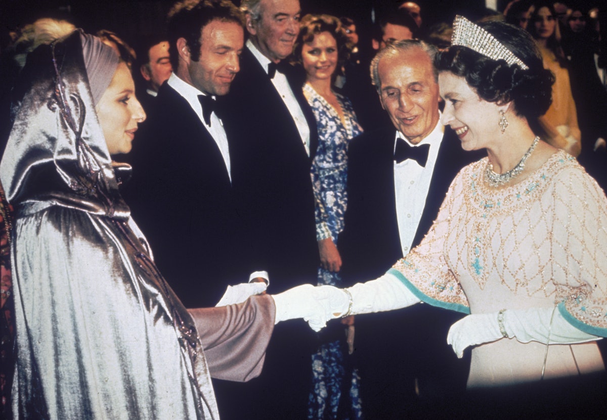 Queen Elizabeth II greets singer and actress Barbra Streisand at the film premiere of 'Funny Lady', ...