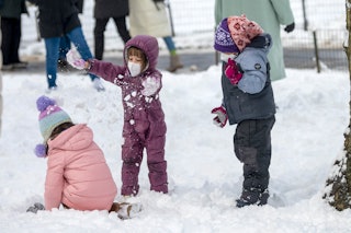 Children play in the snow during the first snow storm of the season in Central Park on January 7, 20...